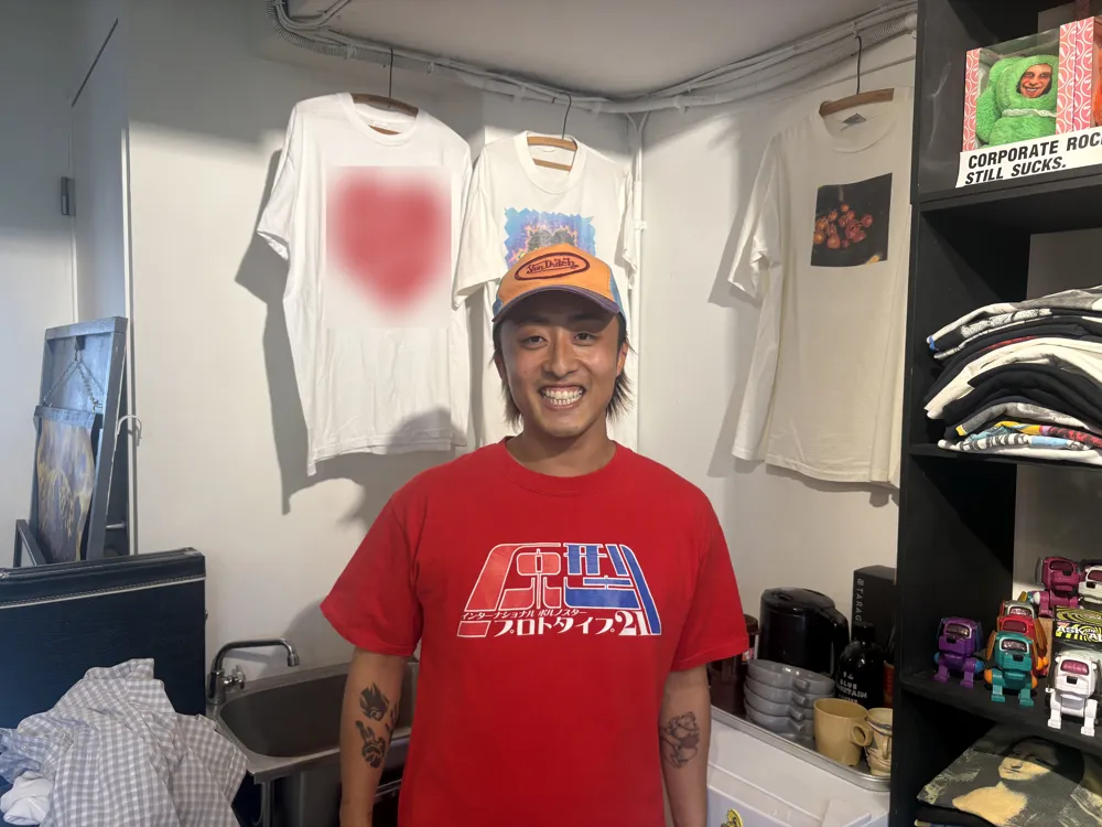 Mr.IDA smiling, in a red T-shirt and an orange cap